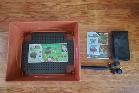 A City Pickers kit with grow box, watering tube, caster wheels, cover and instructions.