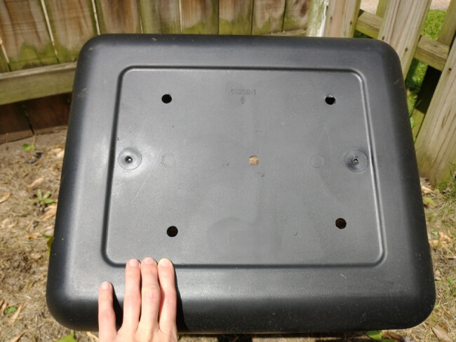Drainage holes drilled in plastic tote bin for a pumpkin container garden. 